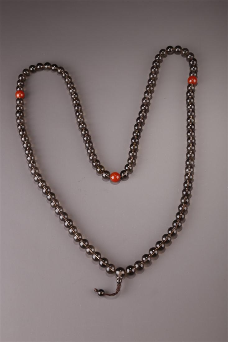 A STRING OF CRYSTAL BUDDHA BEADS. (1 of 7)