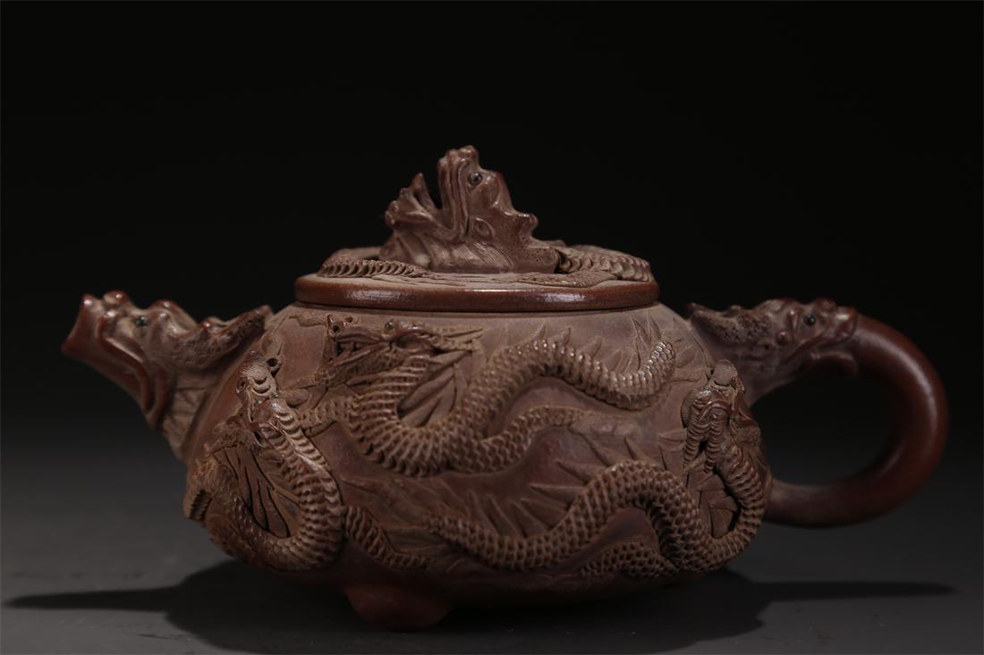 A PURPLE CLAY TEAPOT WITH DRAGON DESIGN. (1 of 10)