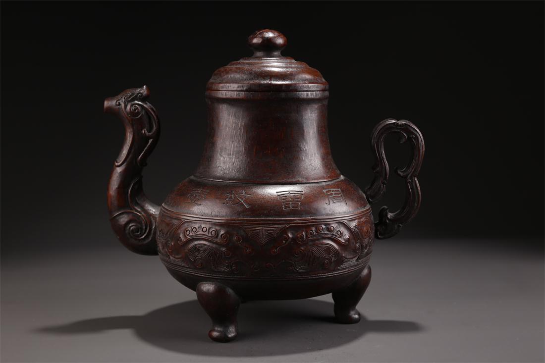 A BAMBOO HANDLED POT WITH BEAST FACE DESIGN. (1 of 9)