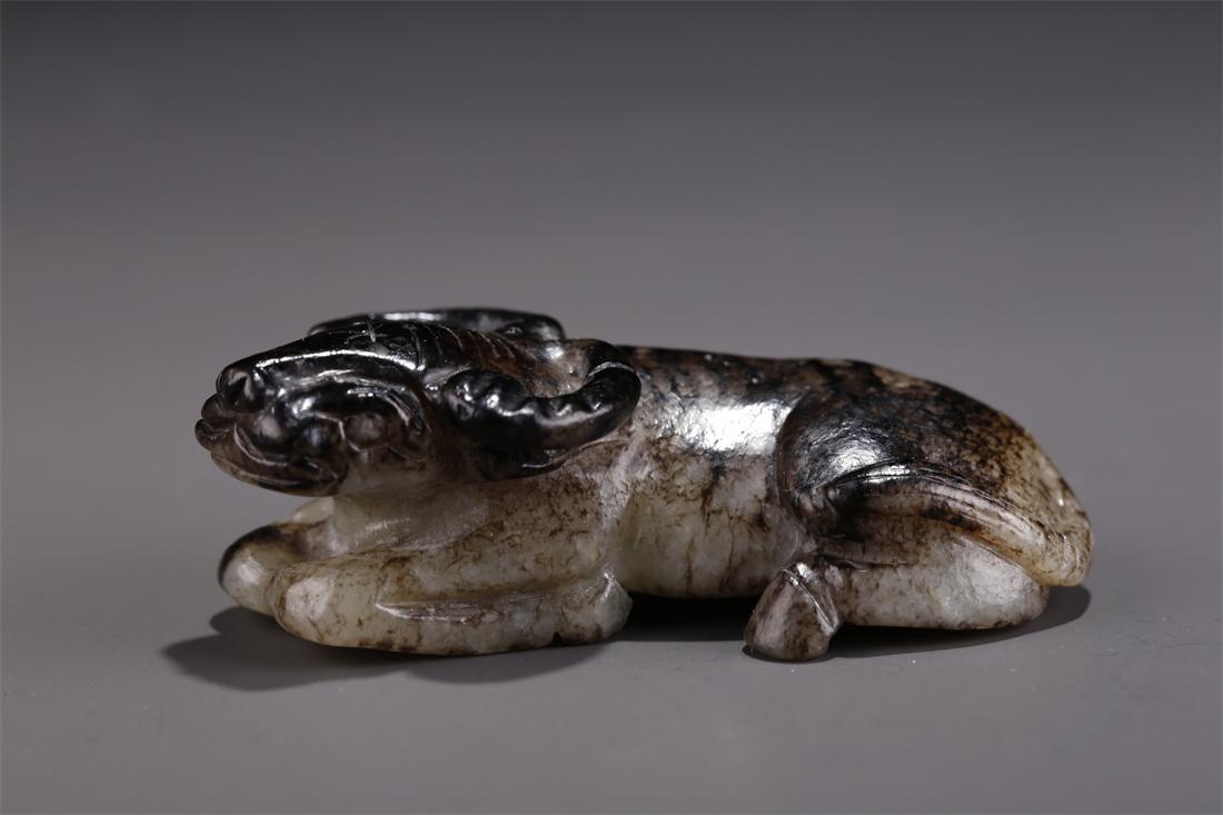 A HETIAN JADE CROUCHING CATTLE CARVING. (1 of 9)