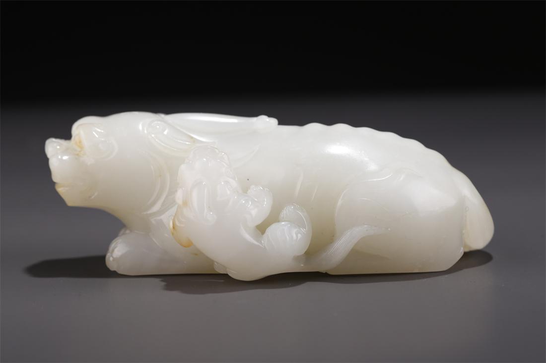 A HETIAN JADE AUSPICIOUS BEAST CARVING. (1 of 8)