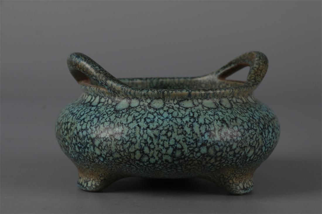 A PURPLE CLAY TRIPOD CENSER WITH TWO EARS. (1 of 9)