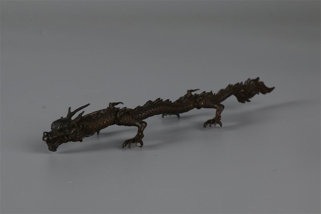 A BRONZE DRAGON STATUE ORNAMENT. (1 of 9)
