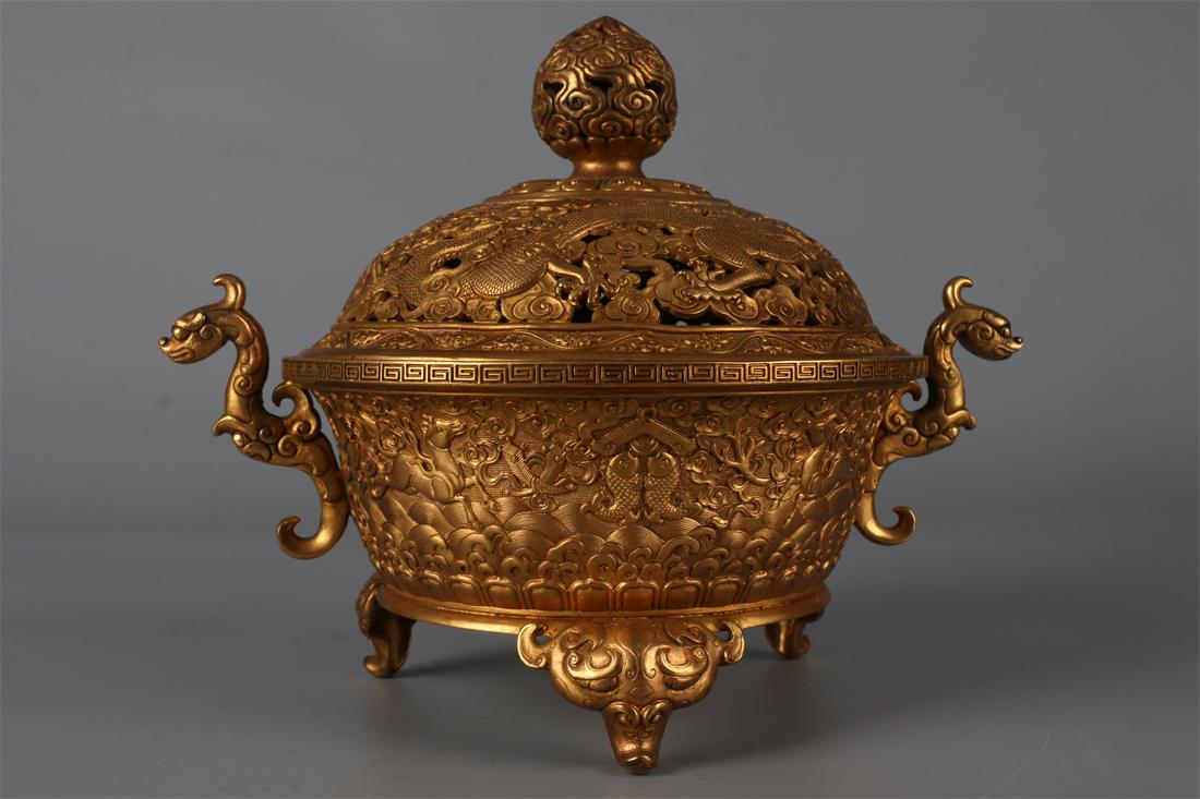 A GILT BRONZE TRIPOD CENSER. (1 of 9)
