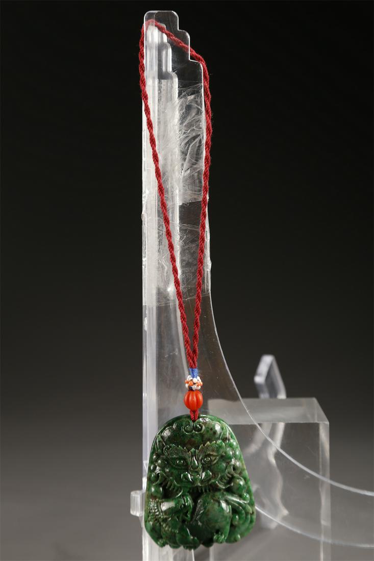 A PURE GREEN JADEITE PENDANT. (1 of 6)