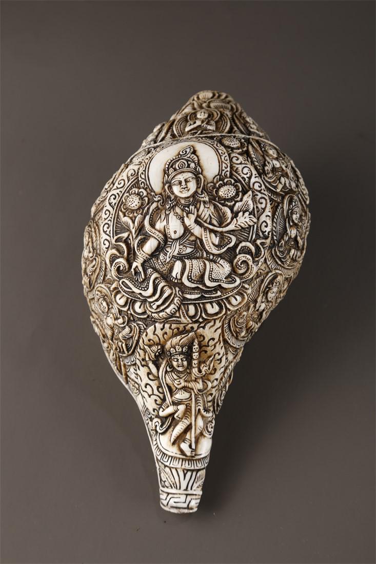 A CONCH IMPLEMENT WITH GREEN TARA DESIGN. (1 of 9)