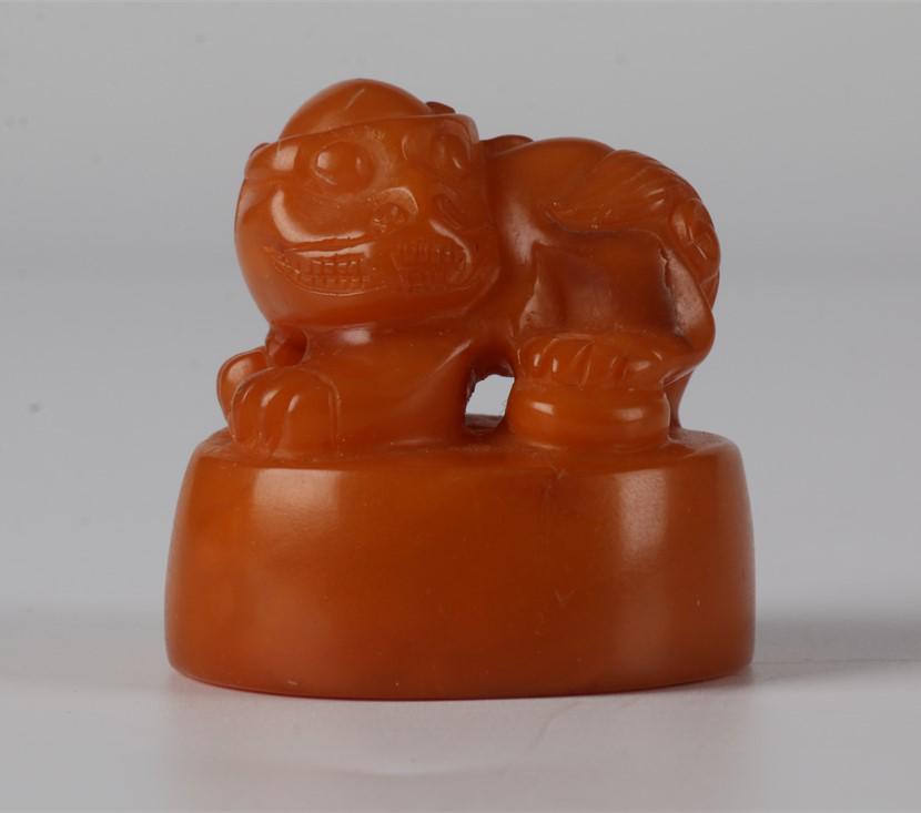 AN AMBER BEESWAX BEAST-KNOB SEAL. (1 of 9)