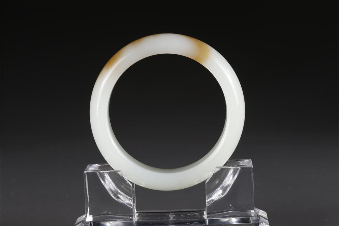 A HETIAN JADE BANGLE WITH BROWN SPECKLE. (1 of 6)