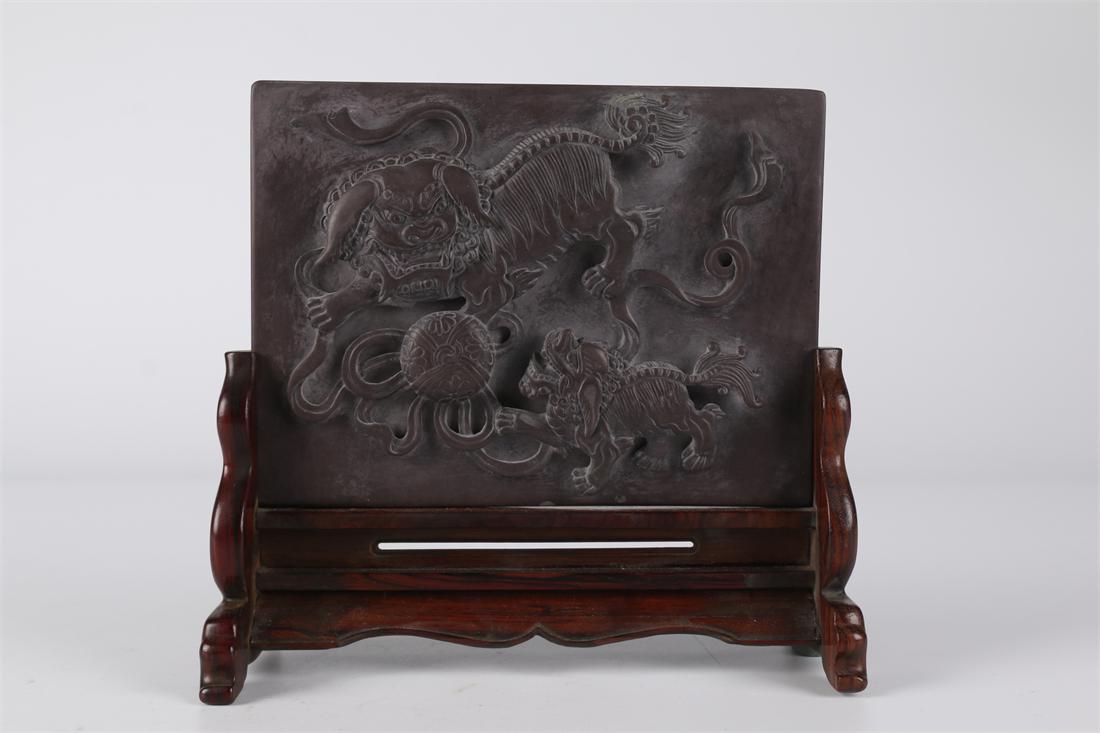 A QIYANG STONE TABLE SCREEN WITH LION DESIGN. (1 of 7)