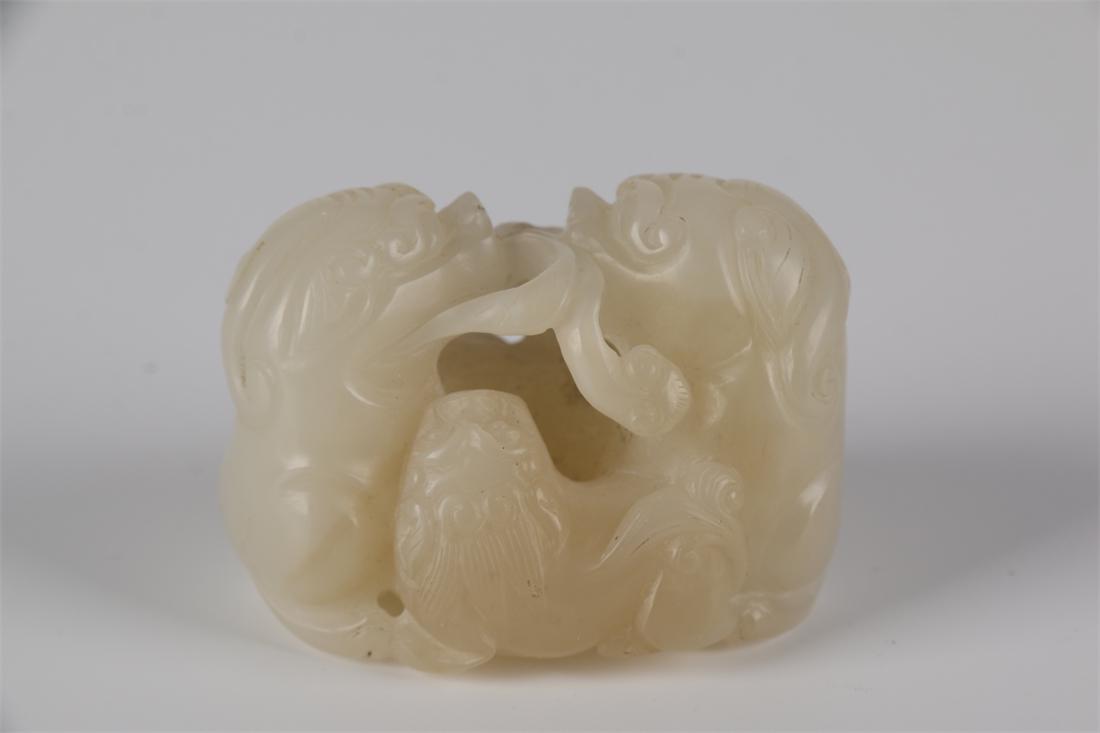 A HETIAN WHITE JADE TRIPLE-LION CARVING. (1 of 7)