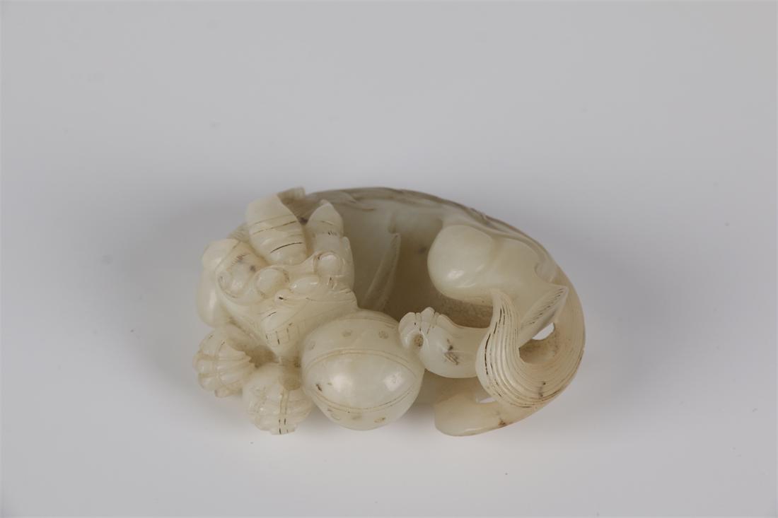 A HETIAN JADE CROUCHING DRAGON CARVING. (1 of 7)