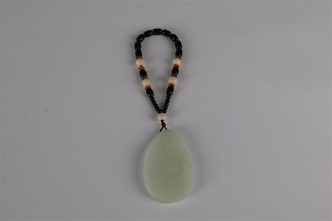 A HETIAN JADE PENDANT WITH LANDSCAPE DESIGN. (1 of 9)