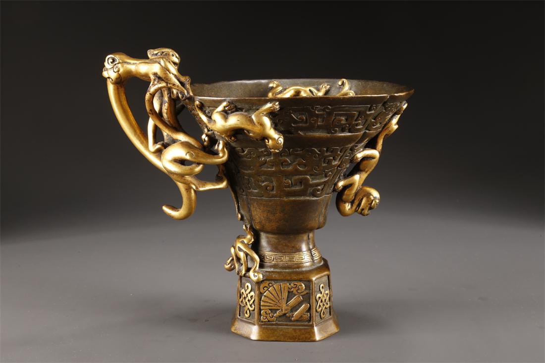 A COPPER CUP WITH DRAGON-SHAPED EARS. (1 of 9)
