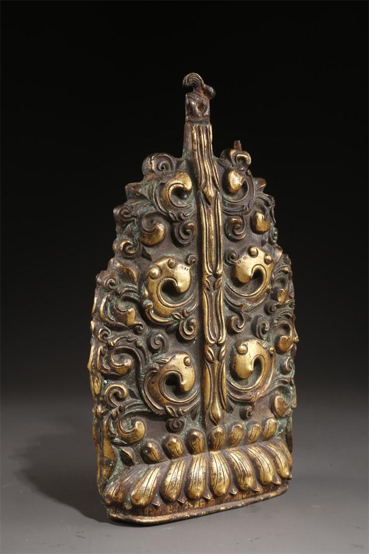 A TIBETAN GILT COPPER OFFERING IMPLEMENT. (1 of 7)