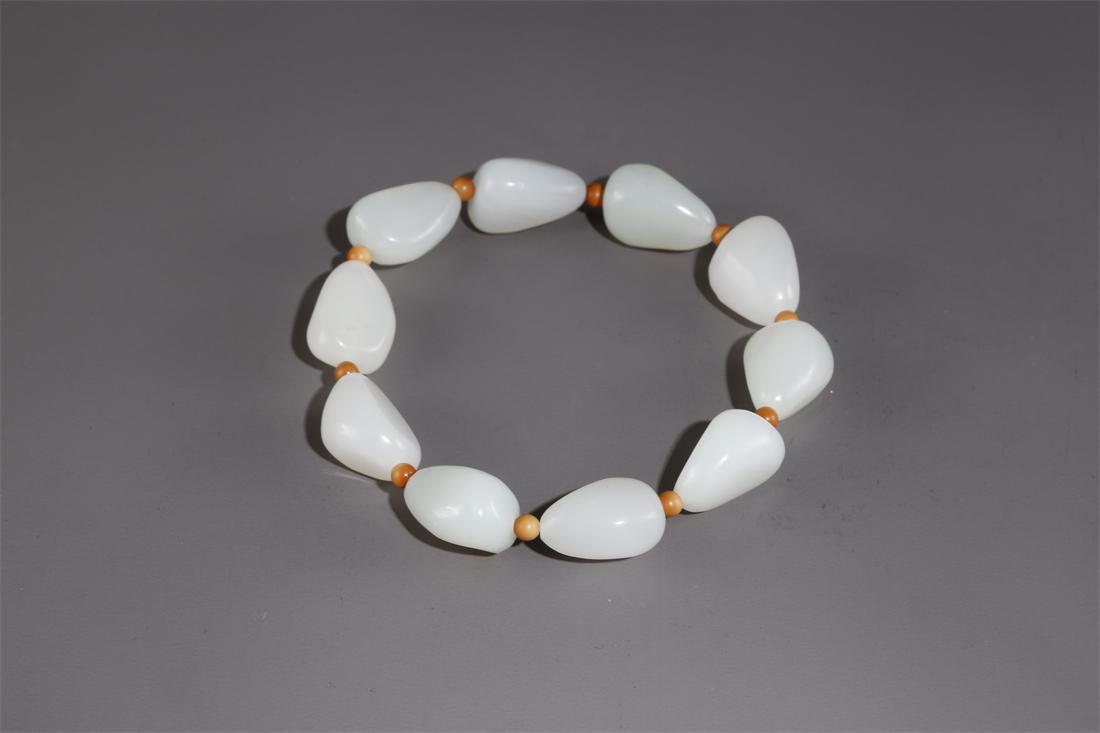 A HETIAN RAW JADE BRACELET. (1 of 6)