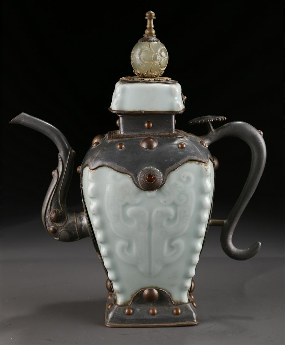 A LIGHT GREEN GLAZED PORCELAIN POT WITH HANDLE. (1 of 9)