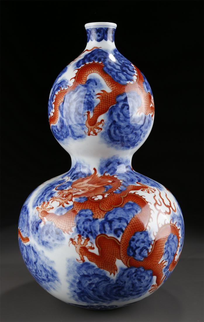 A BLUE-AND-WHITE GOURD-SHAPED PORCELAIN BOTTLE. (1 of 9)
