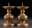 A SET OF GILT BRONZE CANDLESTICKS.