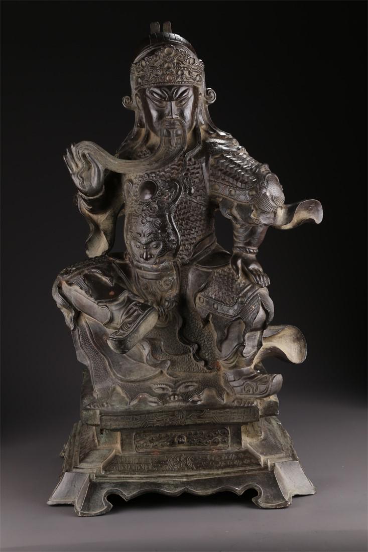 A BRONZE SITTING GUANGONG STATUE. (1 of 10)