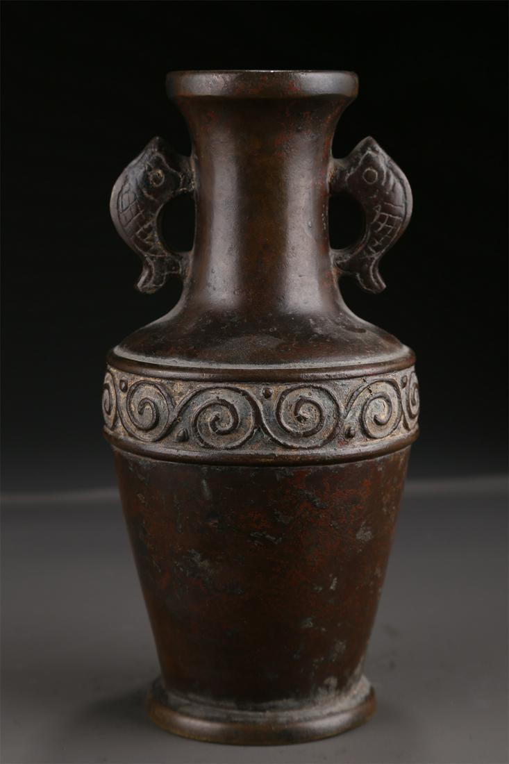 A BRONZE BOTTLE WITH FISH-SHAPED EARS. (1 of 9)
