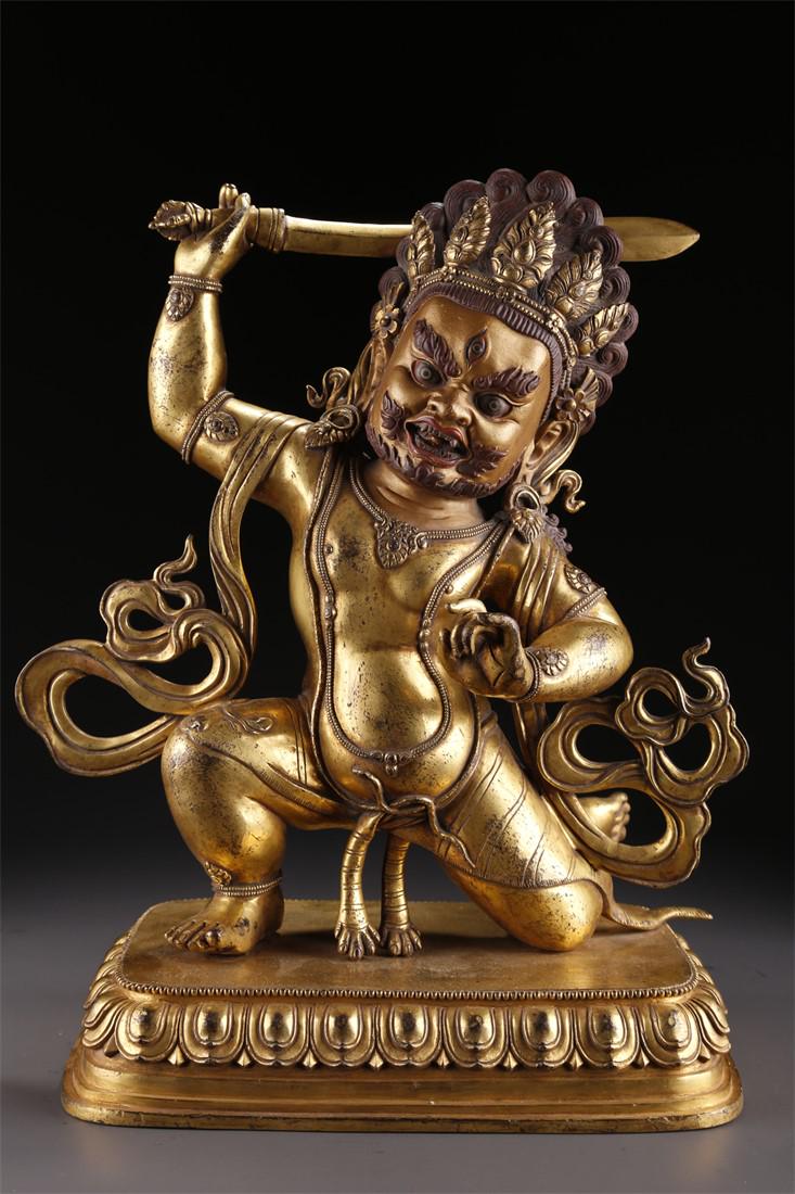 A TIBETAN GILT BRONZE ACALANATHA BUDDHA STATUE. (1 of 9)