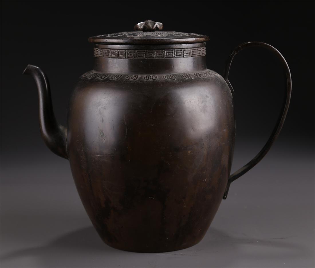 A BRONZE POT WITH HANDLE. (1 of 9)