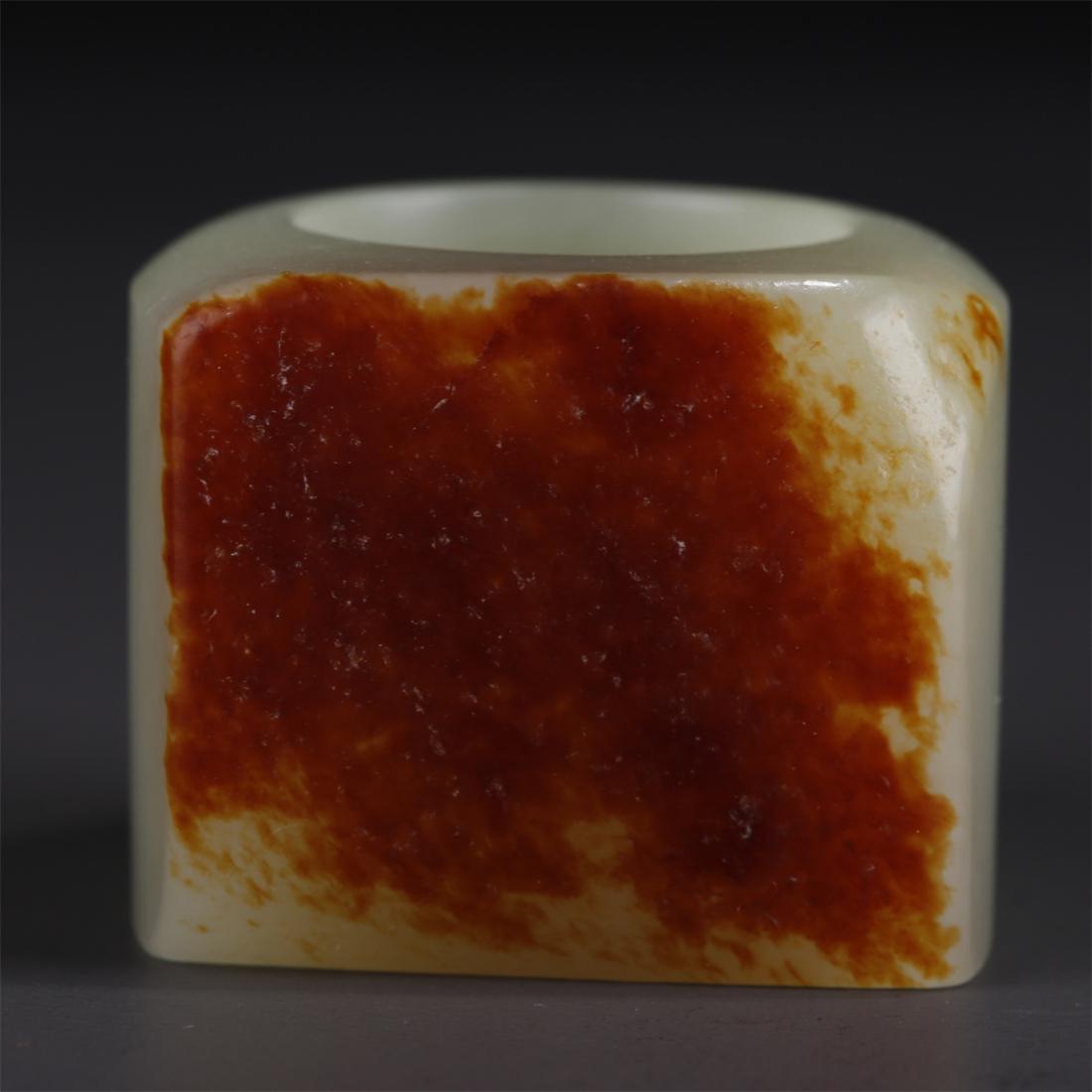 A HETIAN RAW JADE THUMB RING. (1 of 7)