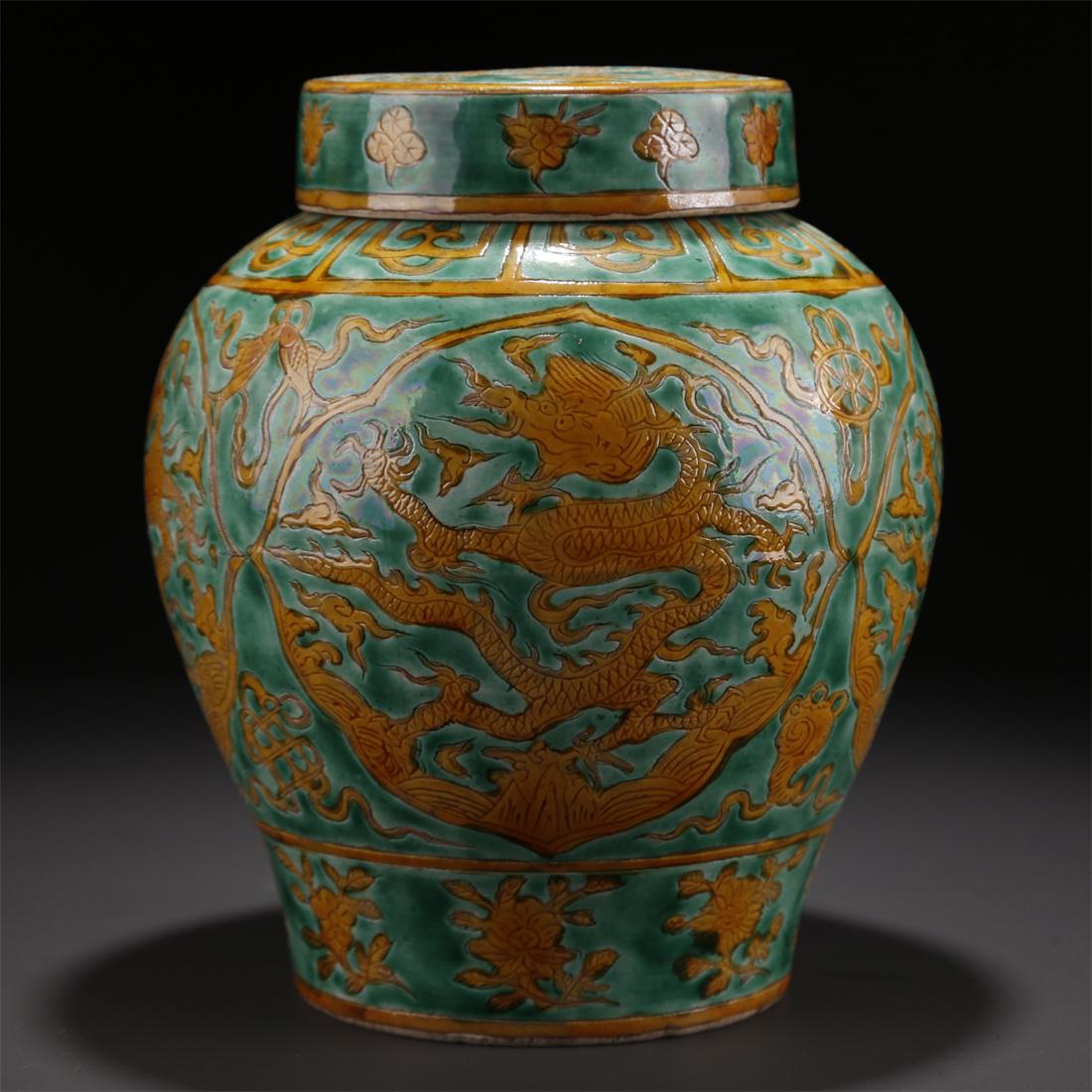 A PORCELAIN JAR WITH DRAGON DESIGN, GREEN BASE. (1 of 9)