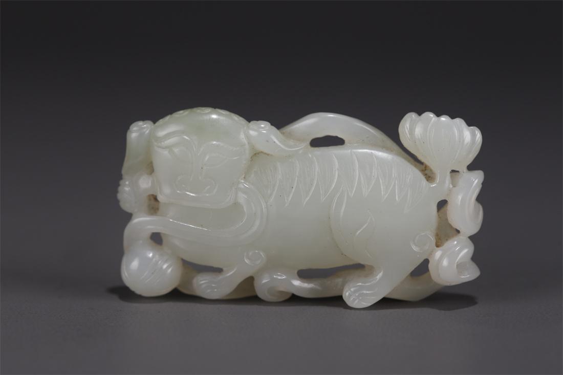 A HETIAN JADE LION AND BALL CARVING PENDANT. (1 of 7)