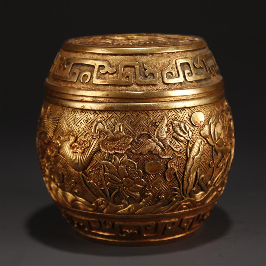 A GILT BRONZE LIDDED JAR WITH FLOWERS DESIGN. (1 of 10)