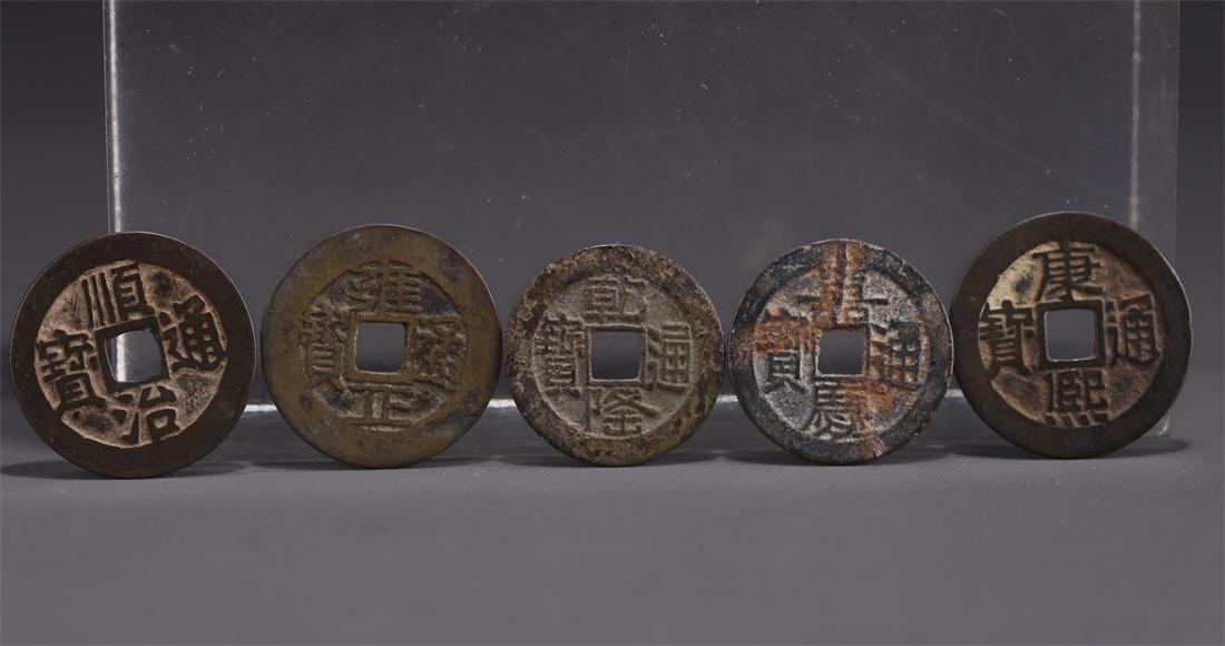 A SET OF FIVE BRONZE COINS. (1 of 8)