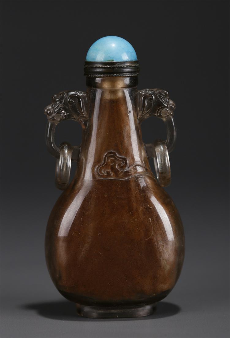 A CRYSTAL SNUFF BOTTLE WITH BEAST-SHAPED EARS. (1 of 9)