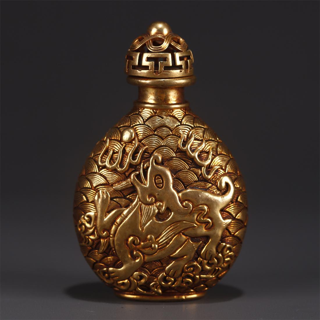 A GILT BRONZE SNUFF BOTTLE WITH BEAST DESIGN. (1 of 8)