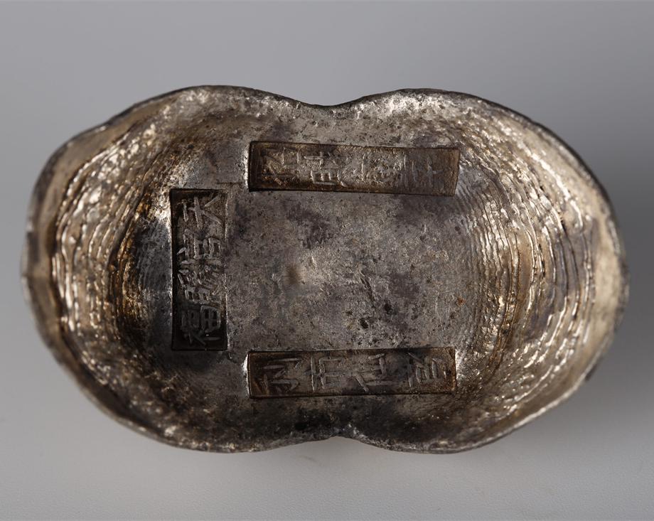 A SHOE-SHAPED SILVER INGOT, QING DYNASTY. (1 of 4)