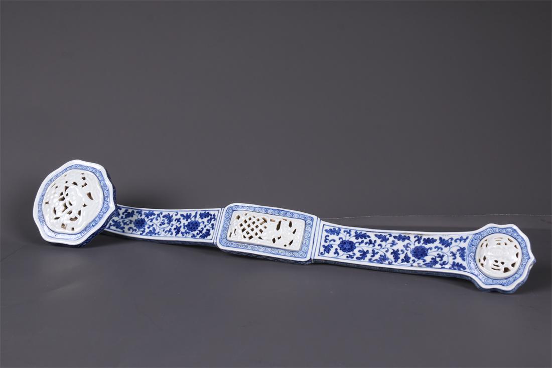 A BLUE-AND-WHITE PORCELAIN RUYI SCULPTURE. (1 of 9)