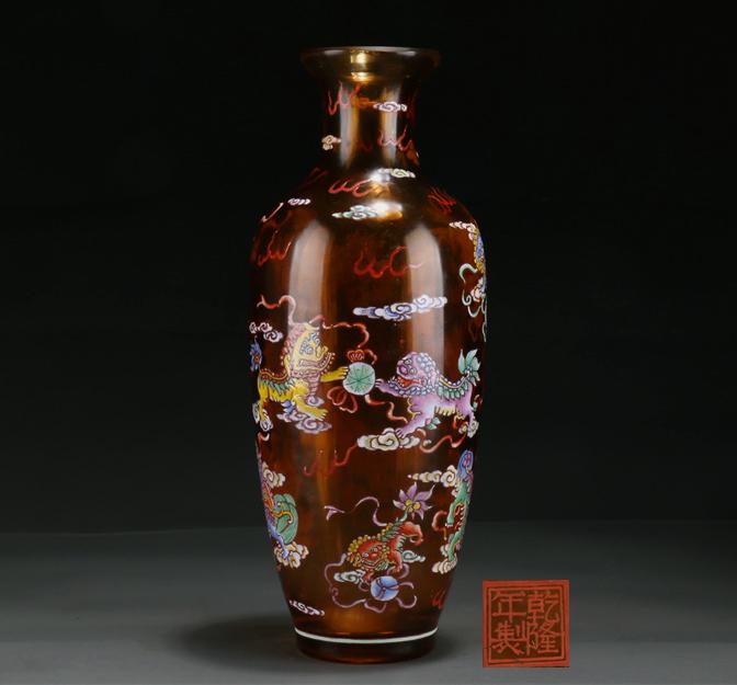 A GLASS BOTTLE WITH LIONS AND BALL MOTIF. (1 of 9)