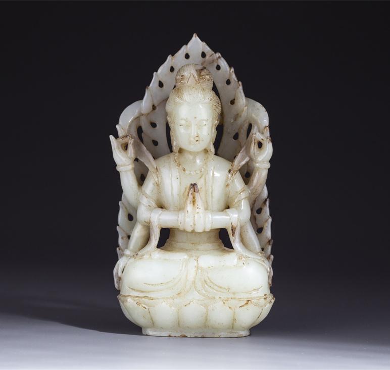 A HETIAN JADE FOUR-ARM AVALOKITESVARA STATUE. (1 of 9)