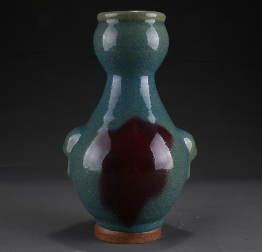 A PORCELAIN BOTTLE WITH BEAST FACE DESIGN. (1 of 8)