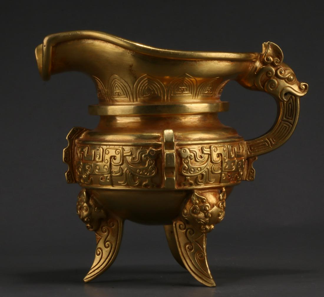 A GILT BRONZE CUP "YI". (1 of 12)