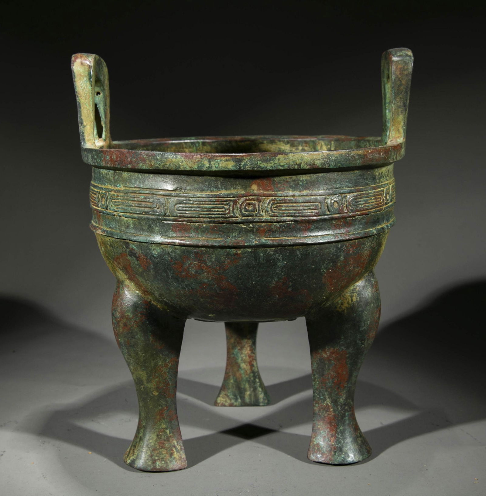 A TRIPOD-SHAPED BRONZE CENSER. (1 of 8)