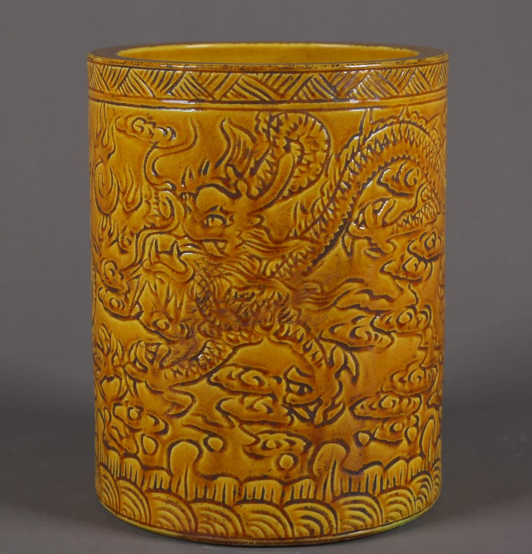 A YELLOW GLAZED PORCELAIN BRUSH POT. (1 of 9)