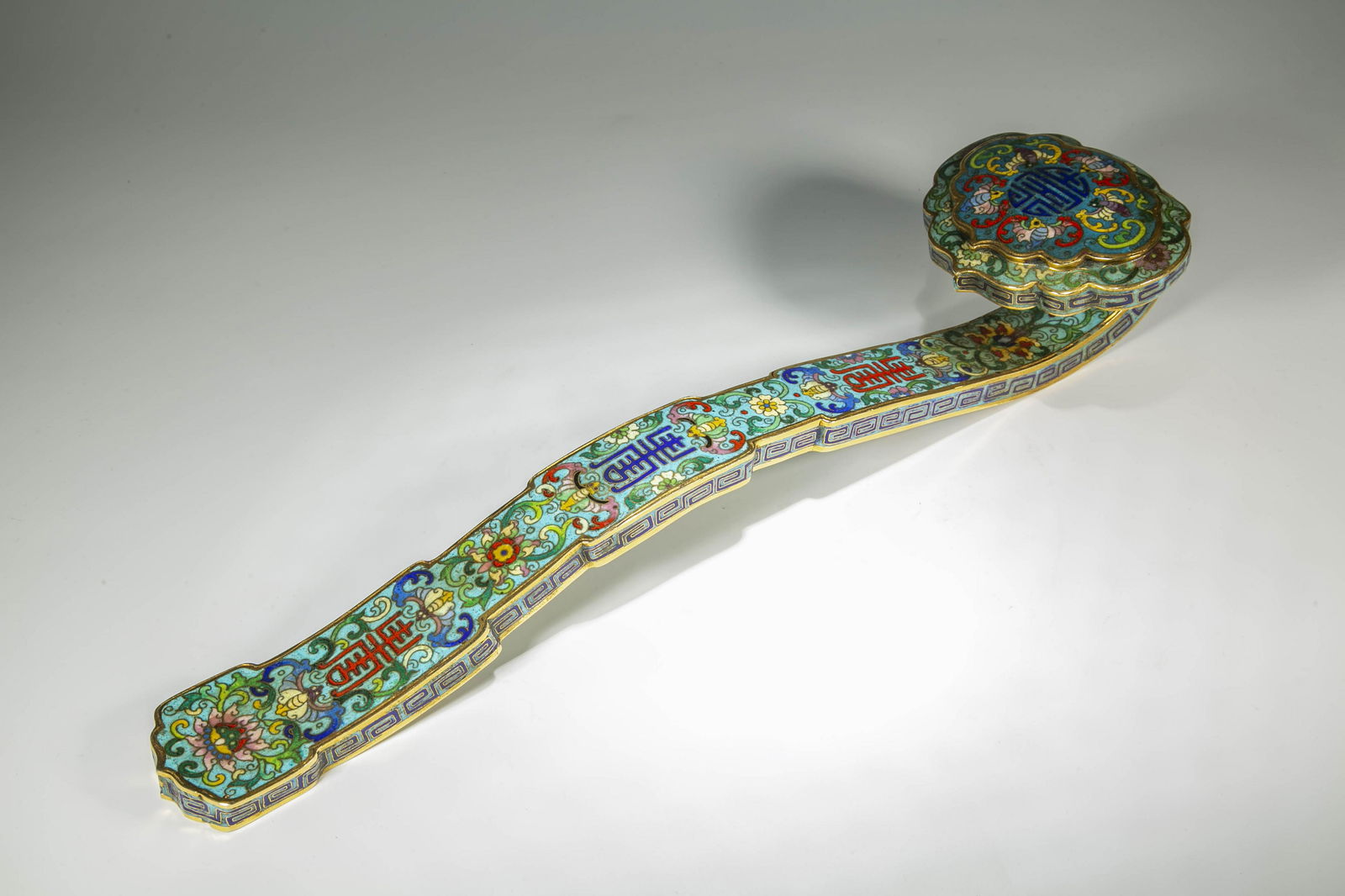 A CLOISONNE ENAMELED BRONZE RUYI SCULPTURE. (1 of 7)