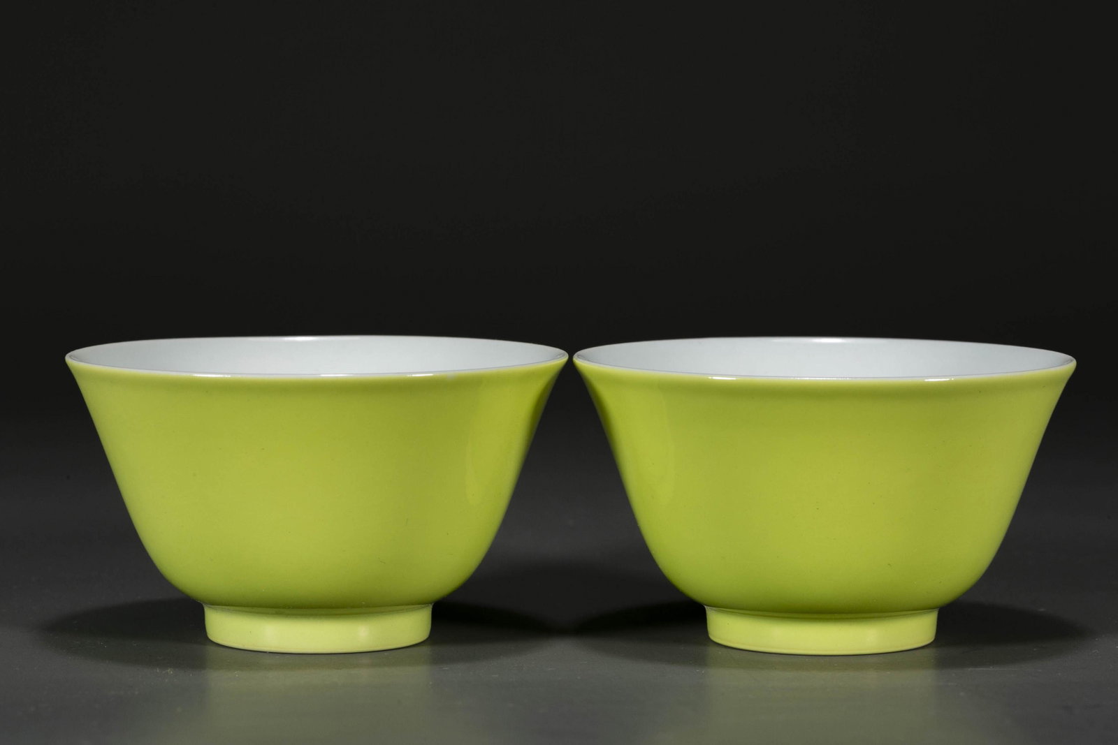 A SET OF YELLOW GLAZED PORCELAIN CUPS.: A Set of Yellow Glazed Porcelain Cups.