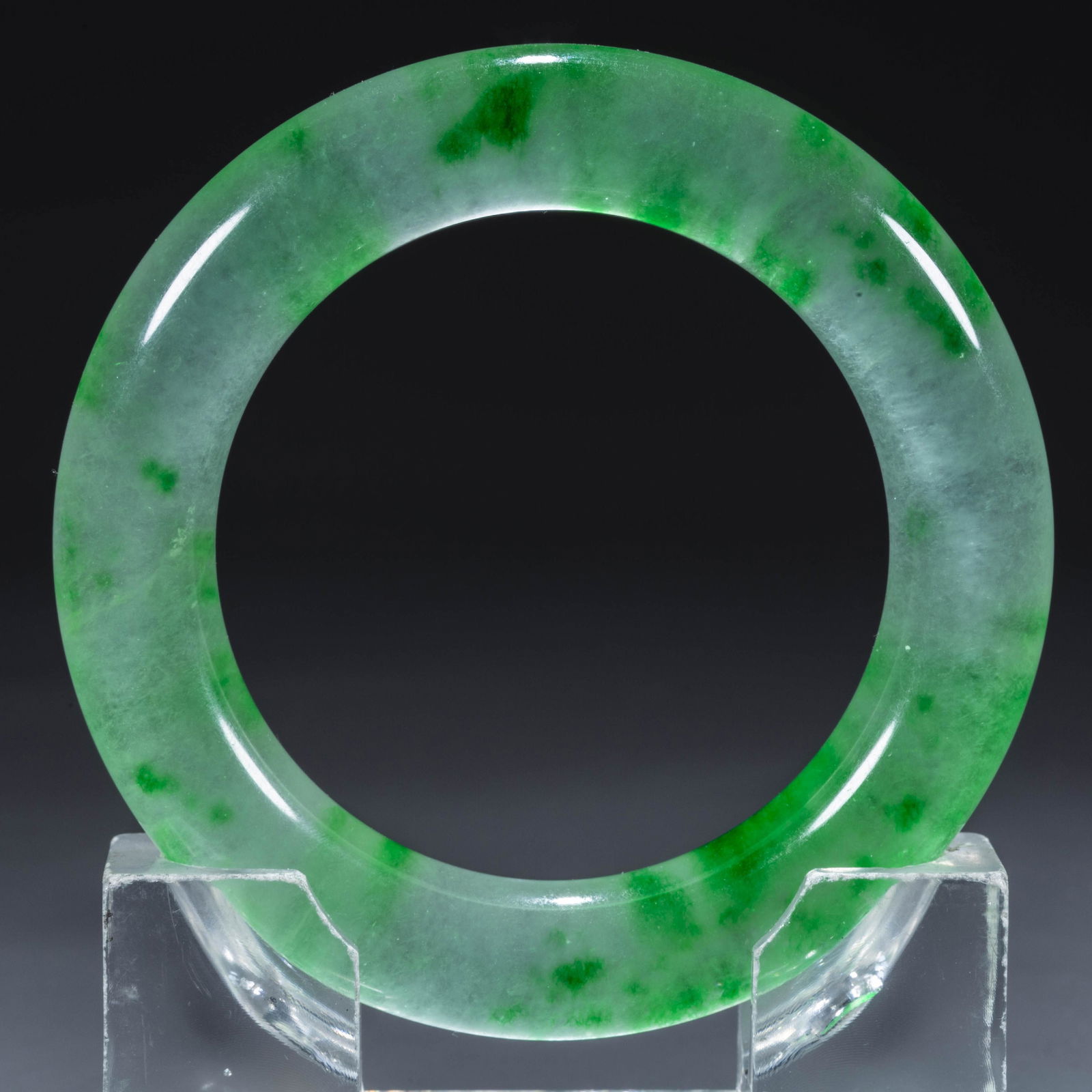 A JADEITE BANGLE.: Jadeite Bangle.