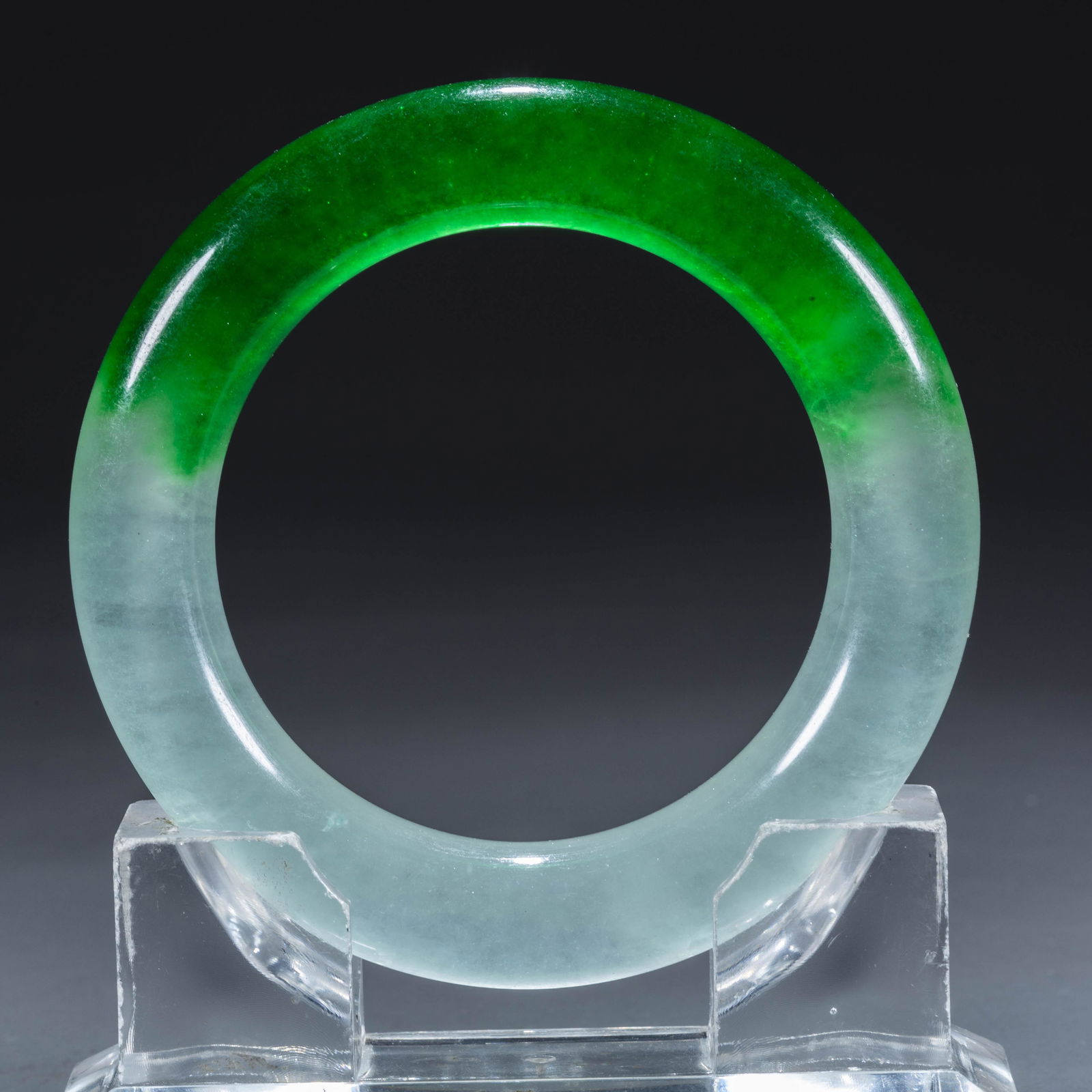 A JADEITE BANGLE.: Jadeite Bangle.