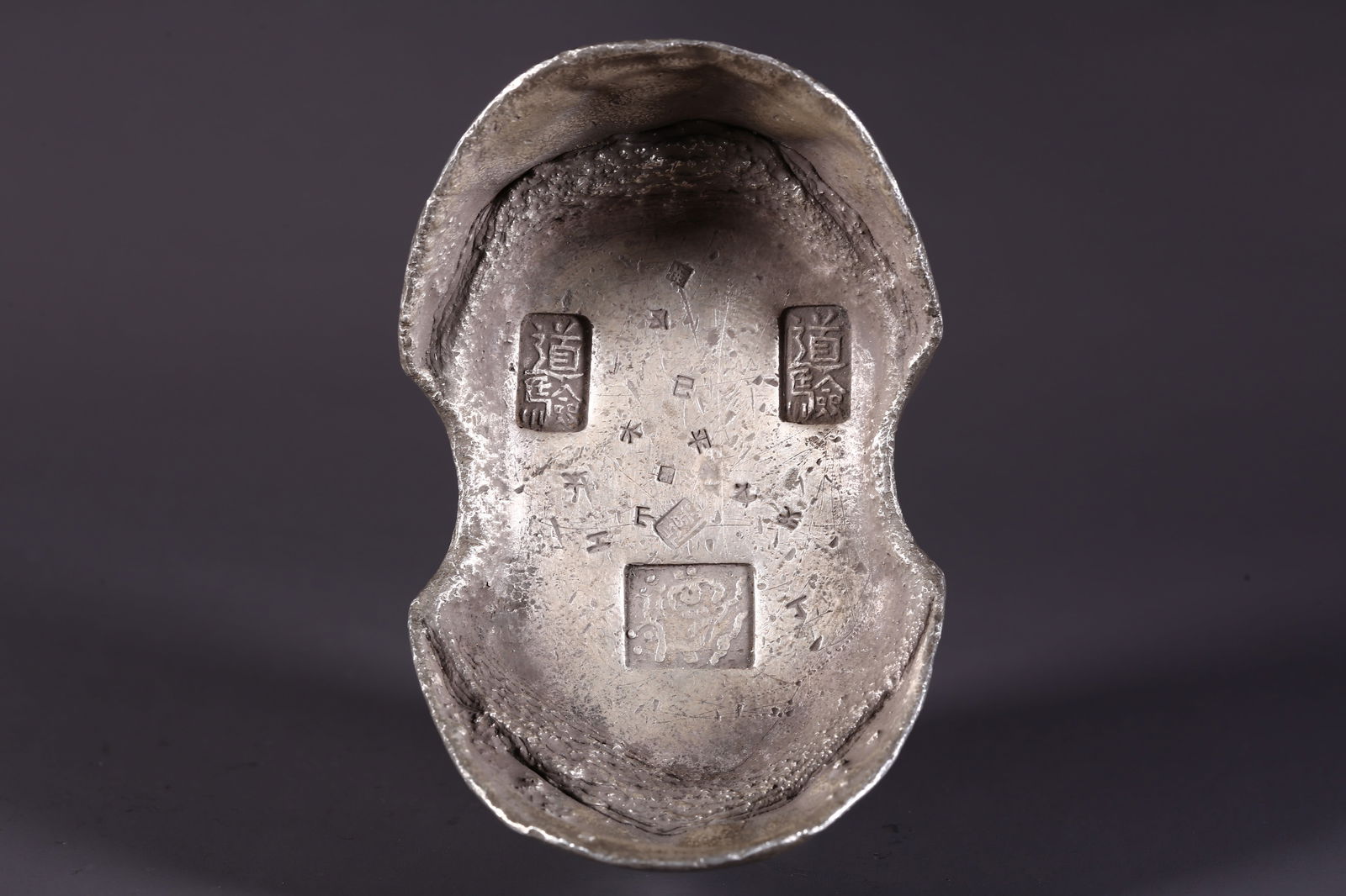 A SILVER INGOT (FIFTY TAELS) (1 of 9)