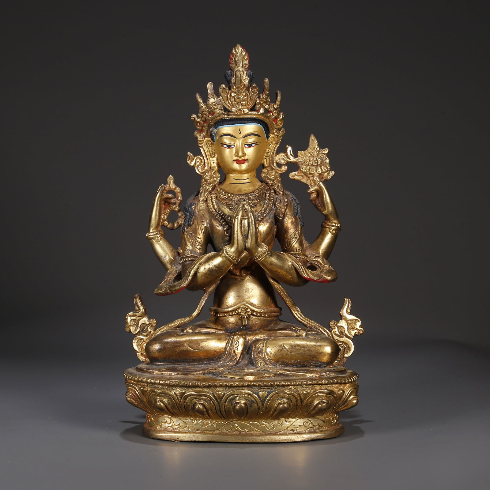 A GILT BRONZE FOUR-ARM AVALOKITESVARA STATUE. (1 of 9)