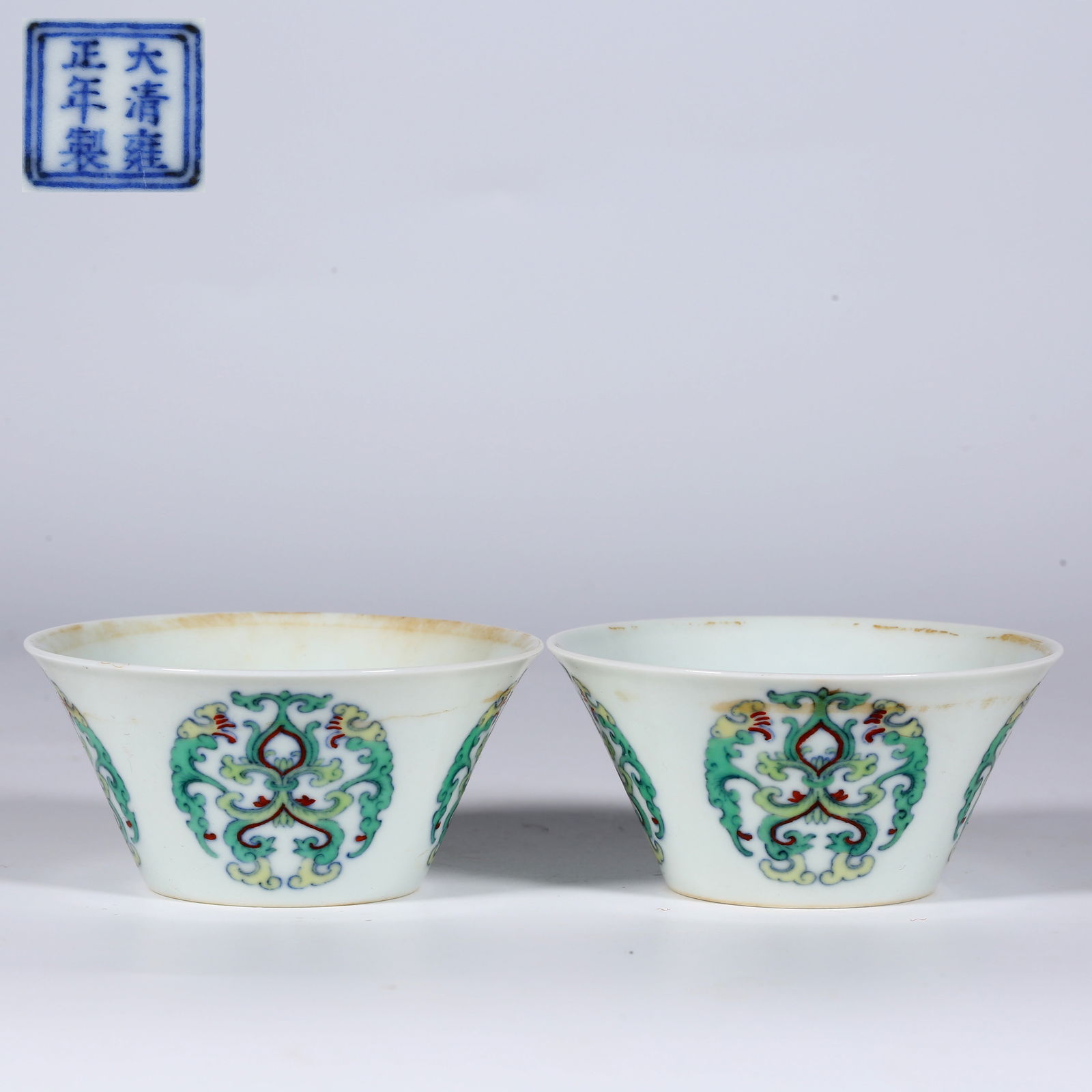 A SET OF HOOF-SHAPED PORCELAIN CUPS.: A Set of Contrasting-Color Hoof-Shaped Porcelain Cups, with Rounded Flowers Design.