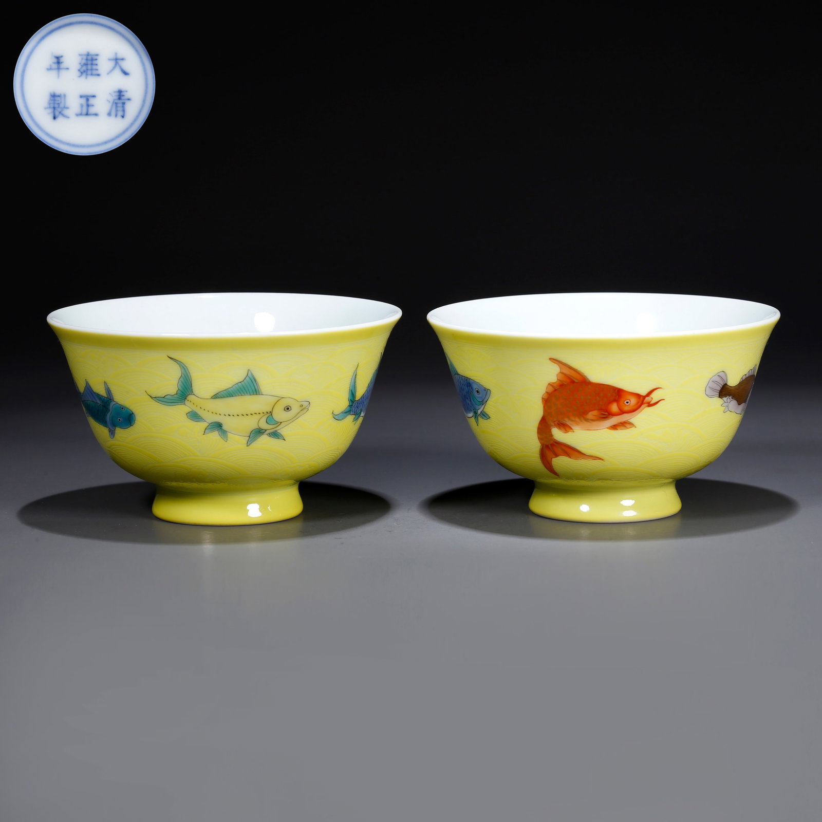 A YELLOW GLAZE FISH MOTIF CUPS (PAIR): Yellow glaze fish motif cups (pair)