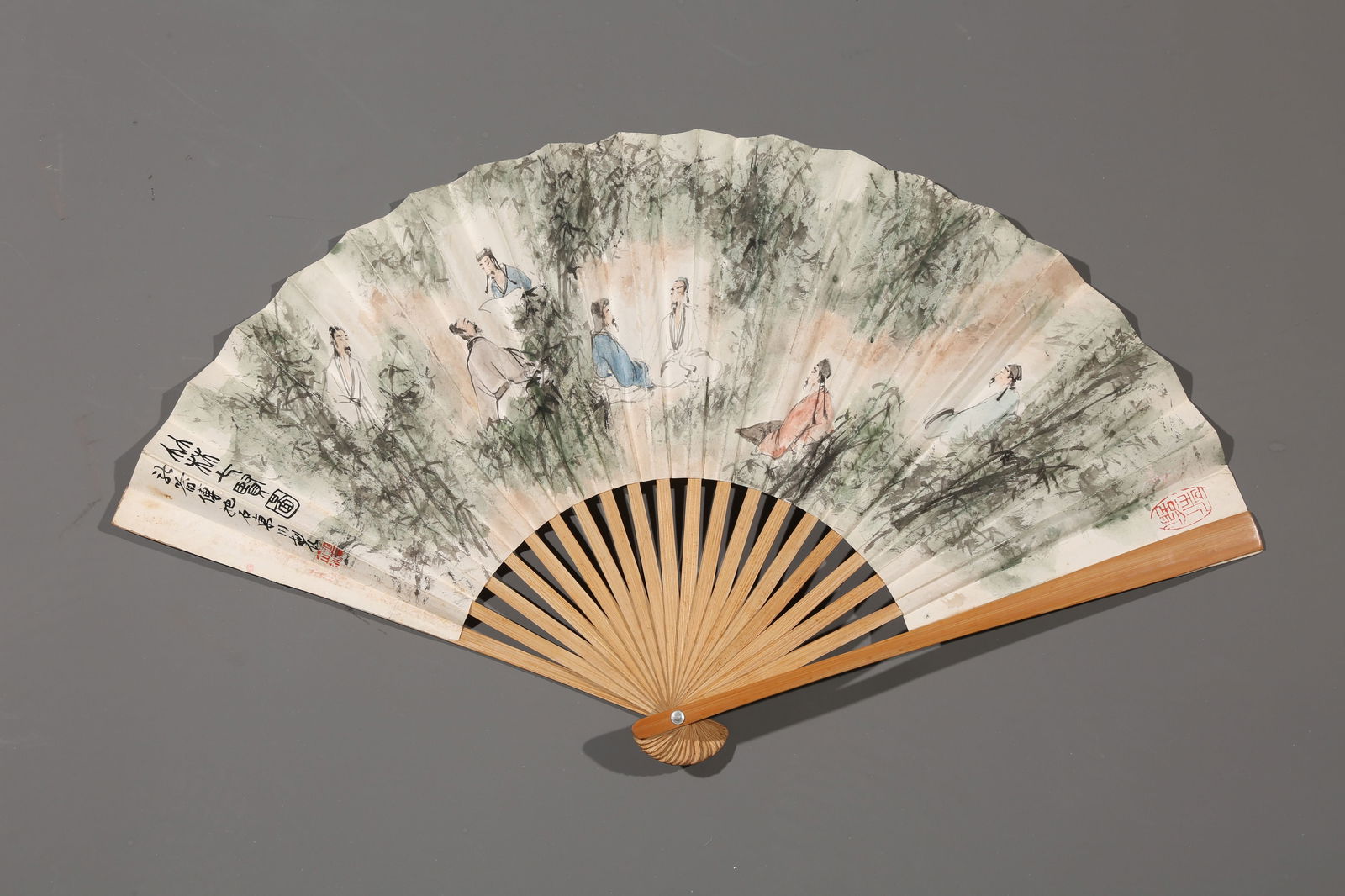 A PAPER FAN PAINTED BY FU BAOSHI FEATURING FIGURES.傅抱石: paper fan painted by Fu Baoshi featuring figures.傅抱石